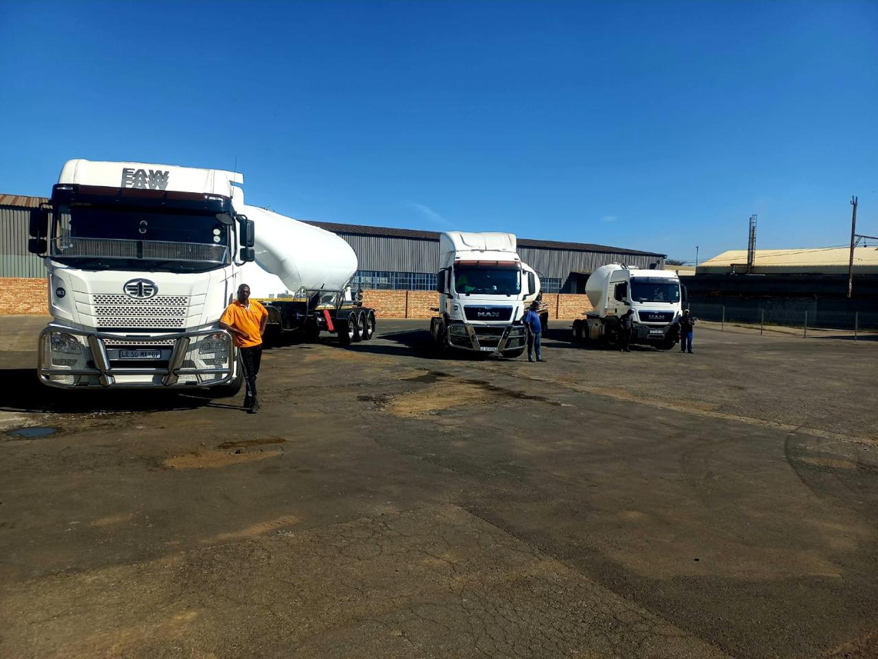Mvuno trucks with drivers in the depot yard